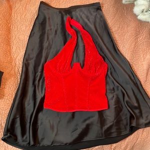 Red cropped shirt and black long skirt